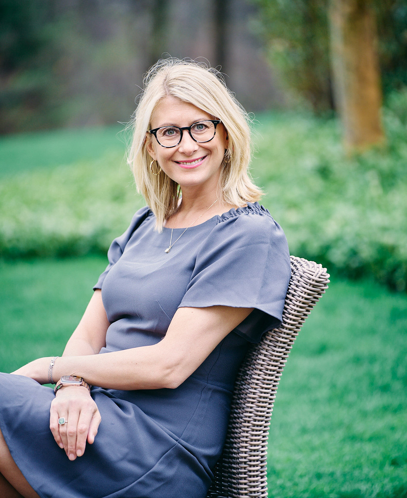 Ali Daggett seated outdoors in her garden